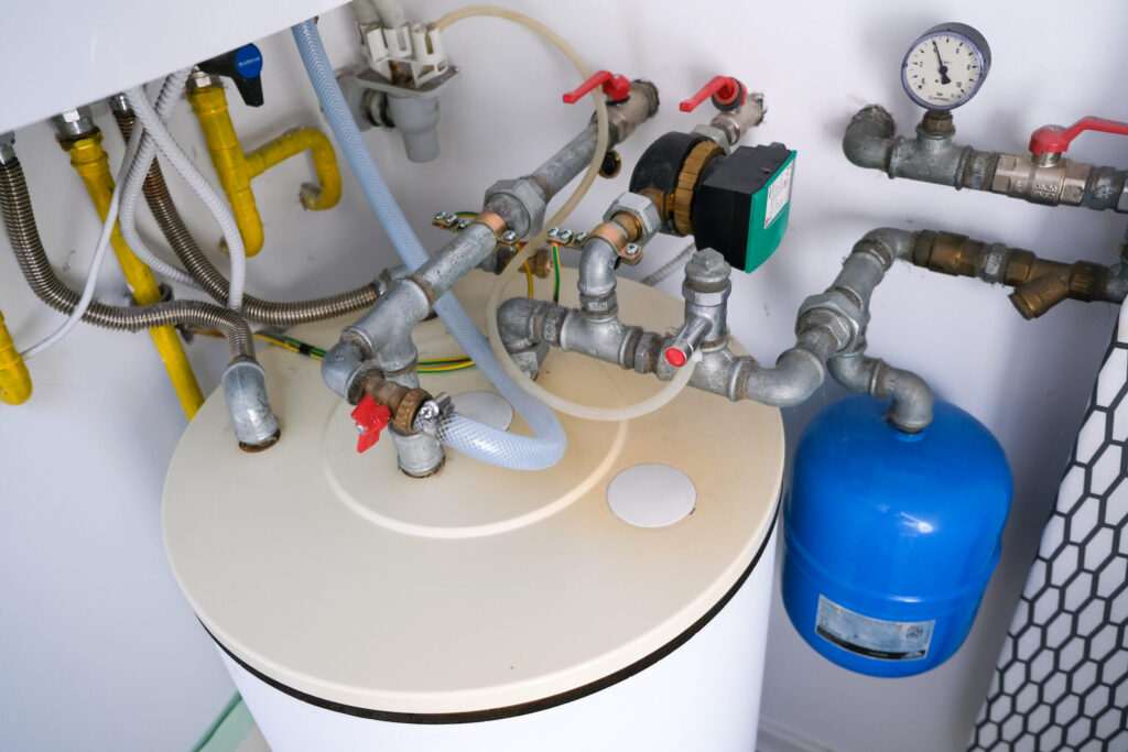 plumbing services Installation of hot water and gas in a home, with water tank and pipes.
